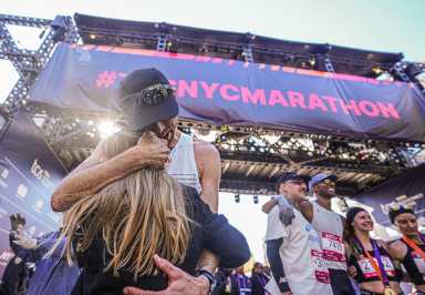 NYC MARATHON | Thousands cross the finish line and complete personal journey in the world's greatest foot race 15 NYC Marathon runner embraces girl at finish line