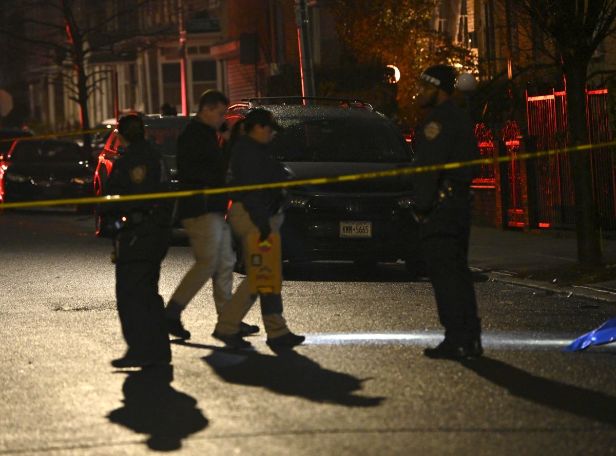 Police in Brooklyn comb the scene where a 28-year-old man was killed in a shooting on Dec. 9, 2024.