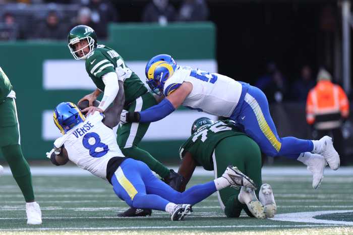 Braden Fiske #55 of the Los Angeles Rams tackles Aaron Rodgers #8 of the New York Jets during the second quarter at MetLife Stadium on Dec. 22, 2024.