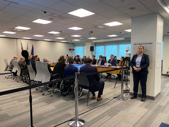 Hundreds of open gangway subway cars to start rolling into NYC by 2027 2 MTA committee meeting with people around a table discussing new subway cars in NYC