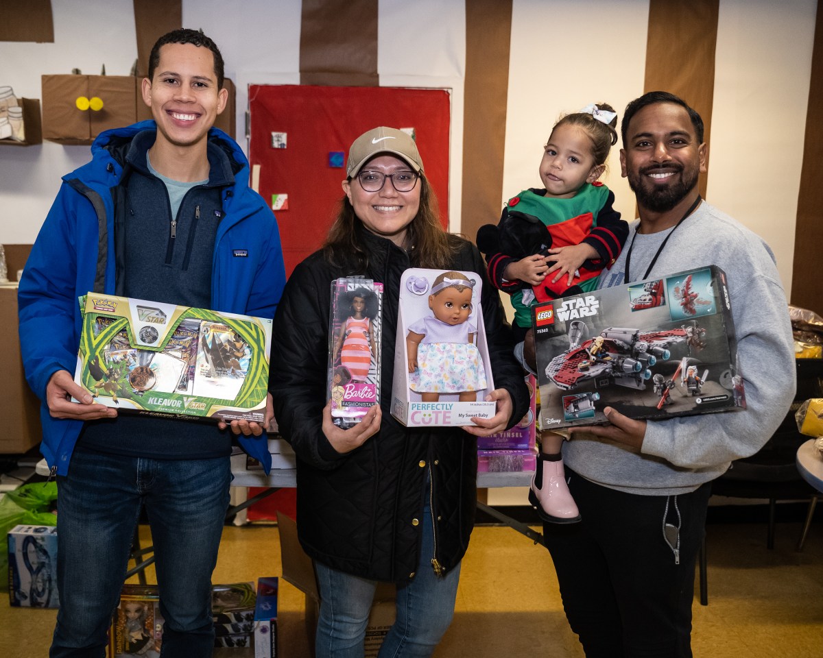 Spreading holiday joy: Unique Manhattan 'toy store' helps restore the spirit of the season 2 Volunteer Shane Spring, Priscilla Perumalla, and Pastor Stephen Perumalla show some of the toys at "His Toy Store" in Manhattan