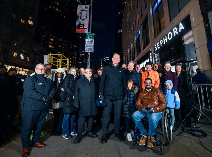 IT'S ON: NYC opens first-in-the-nation congestion pricing toll program in Manhattan 4 group of people next to a congestion pricing sign at night