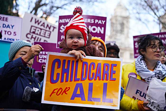 Universal childcare push at City Hall park sees hundreds of parents and tots urge City Hall to lift economic hardships, provide free programs 5 Child and parent holding up sign seeking universal childcare