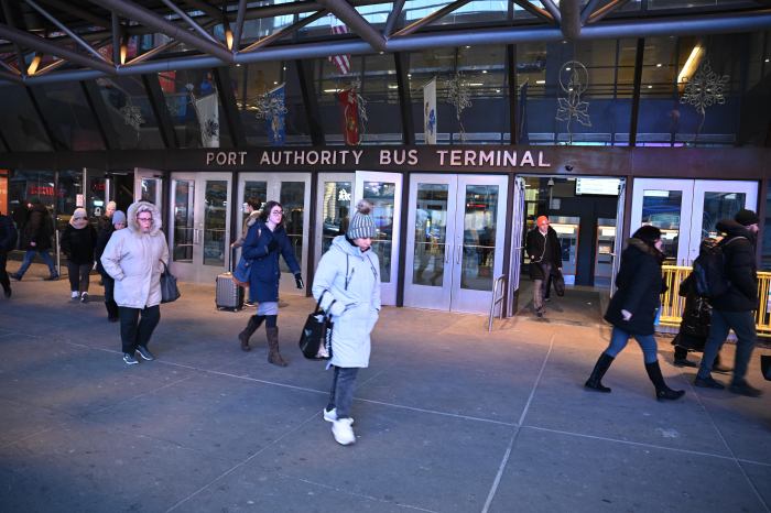 Congestion pricing: Cabbies and commuters continue to fume over Manhattan toll era 2 people walking outside port authority bus terminal in NYC in daytime
