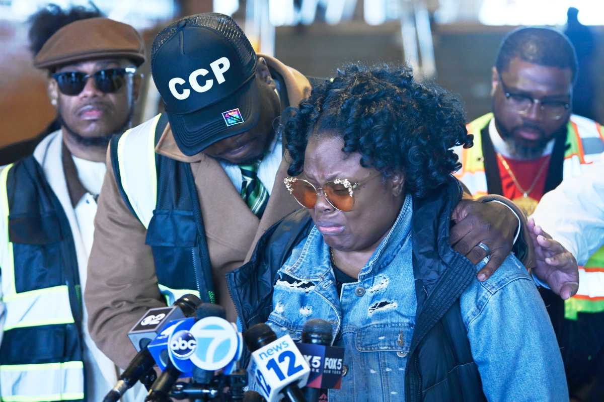 Rev, Kevin McCall (left) stands with Monique Whyte whose son was assaulted at Stillwell Ave train station on Wednesday morning.