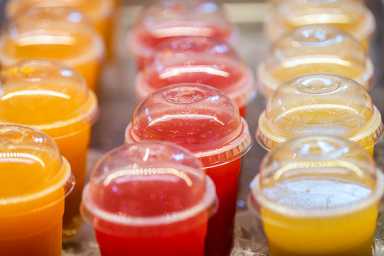 Study shows that sugar-free slushies could be harmful for children 18 Closeup of many red yellow juice drink cocktail plastic cups beverages and cover in shop store counter in summer