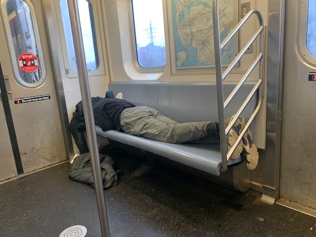 person homeless on NYC trains