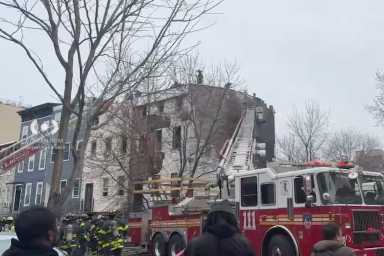 Firefighters at scene of Brooklyn fire where firefighter suffered cardiac arrest