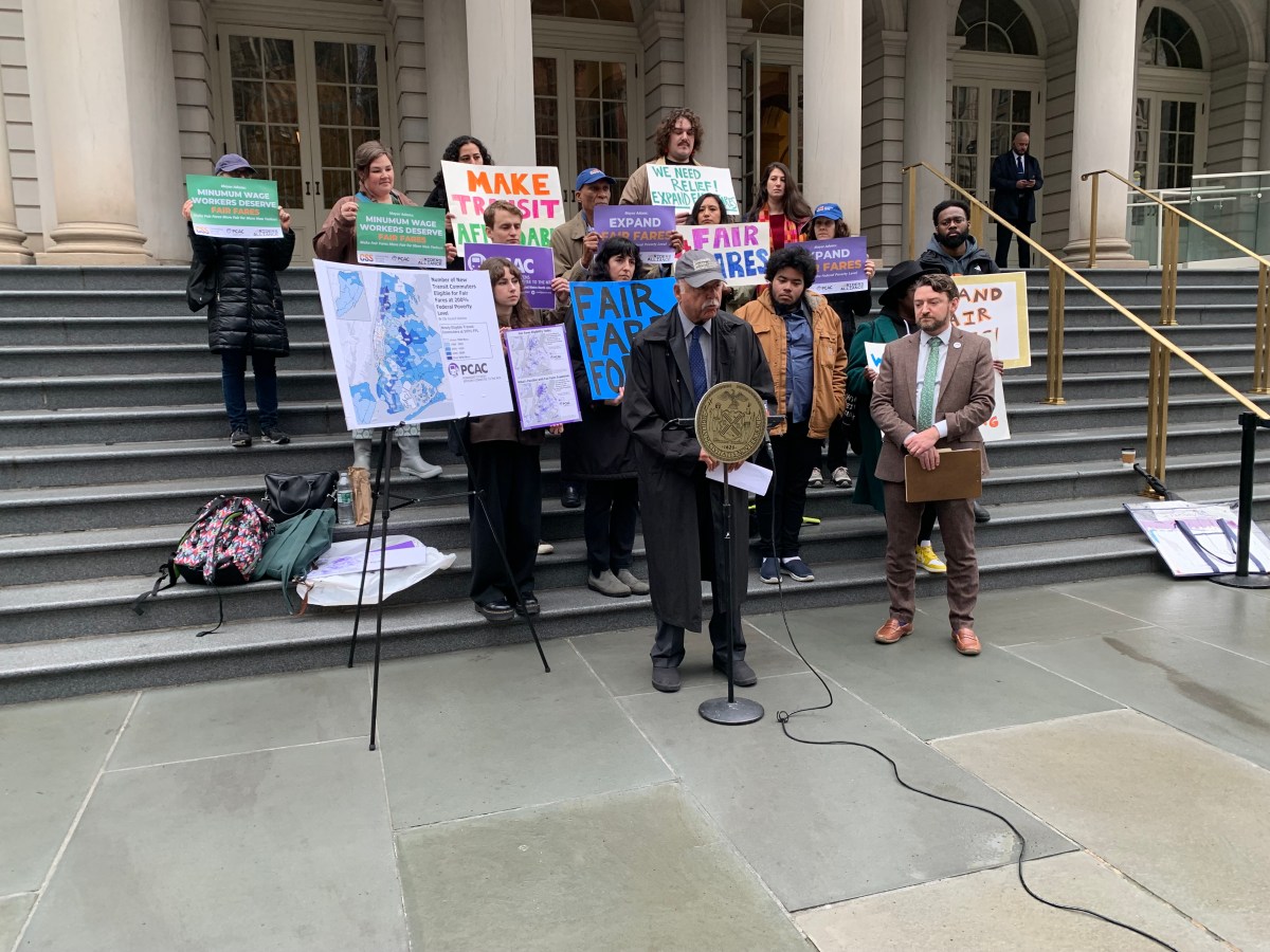 Advocates urge Mayor Adams to expand Fair Fares transit discount program 2 people on stairs outside, advocating for Fair Fares