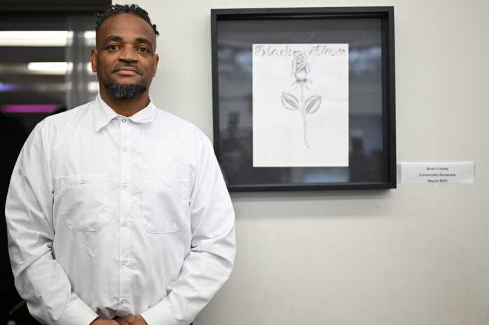 The art of confinement: Rikers Island detainees' work goes on display in Brooklyn 4 Brian Croskey poses alongside his artwork 'Black Flower.' He recreated the piece, dedicated to his sister, during a Black History event on Rikers this year. The original proudly hangs in his sister's home.