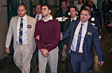 Luigi Mangione in shackles after being charged with murder