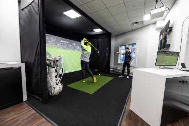A customer tries out clubs at True Spec Golf