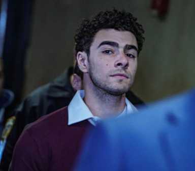 Luigi Mangione pictured being escorted by detectives at Manhattan Federal Court in December 2024.