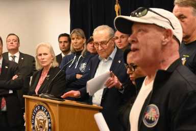 New York senators demand Trump Administration restore 'revolting' cuts made to WTC Health Program for 9/11 first responders 11 people at a podium during a rally for the WTC Health Program
