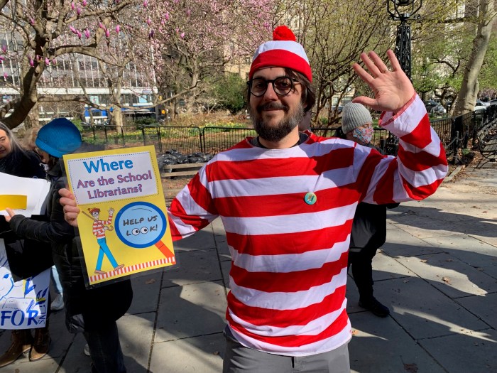 man dressed as Where's Waldo? advocating for public school libraries in NYC