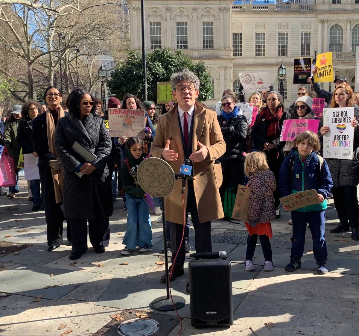 people gathering outside to restore public school libraries in NYC
