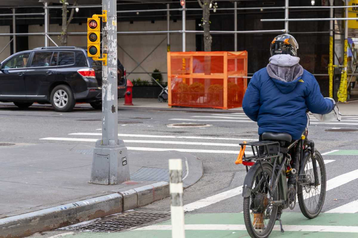 person riding a bike in a bike lane with signal in NYC