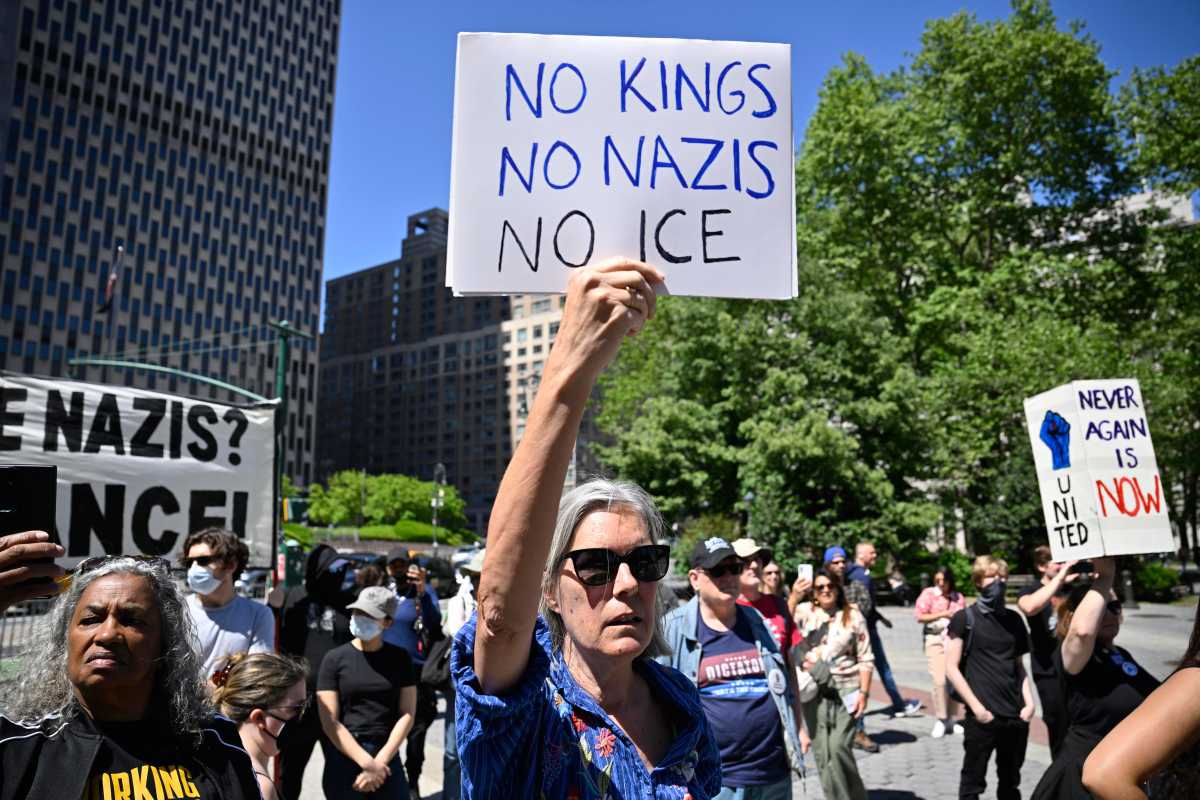 Manhattan rally blasts ICE as 'Trump's gestapo' a day after NJ mayor arrested while visiting immigrant detention center 2 Woman holds sign up against ICE and Nazis during rally in Manhattan