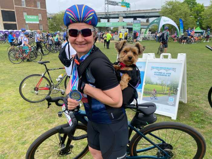 What rain? Thousands turn out for TD Five Boro Bike Tour through NYC on Sunday despite dreary skies 3 woman an small dog on a bike