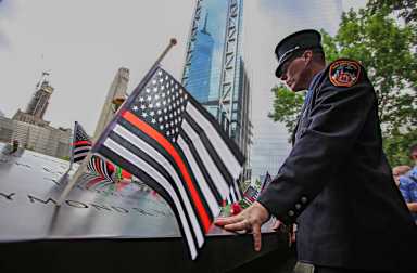 'Outrageous betrayal': NY senators seethe as Trump admin slashes 9/11 health program staffing 4 firefighter mourns at 9/11 memorial with black and white american flag with red stripe