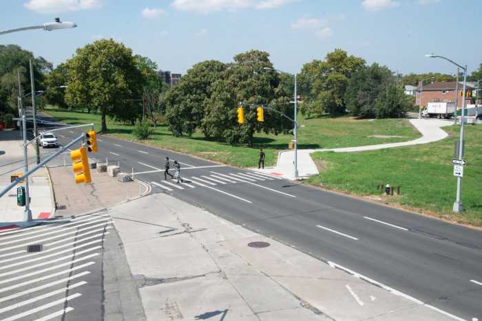 Conduit Avenue in Queens with people walking in a crosswalk