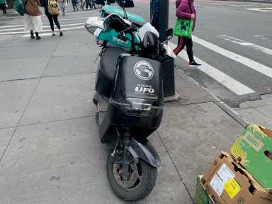 a parked moped on a NYC street