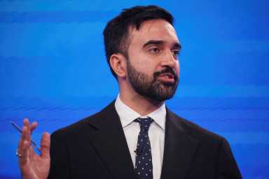 man with beard and suit speaking at NYC mayor debate Zohran Mamdani