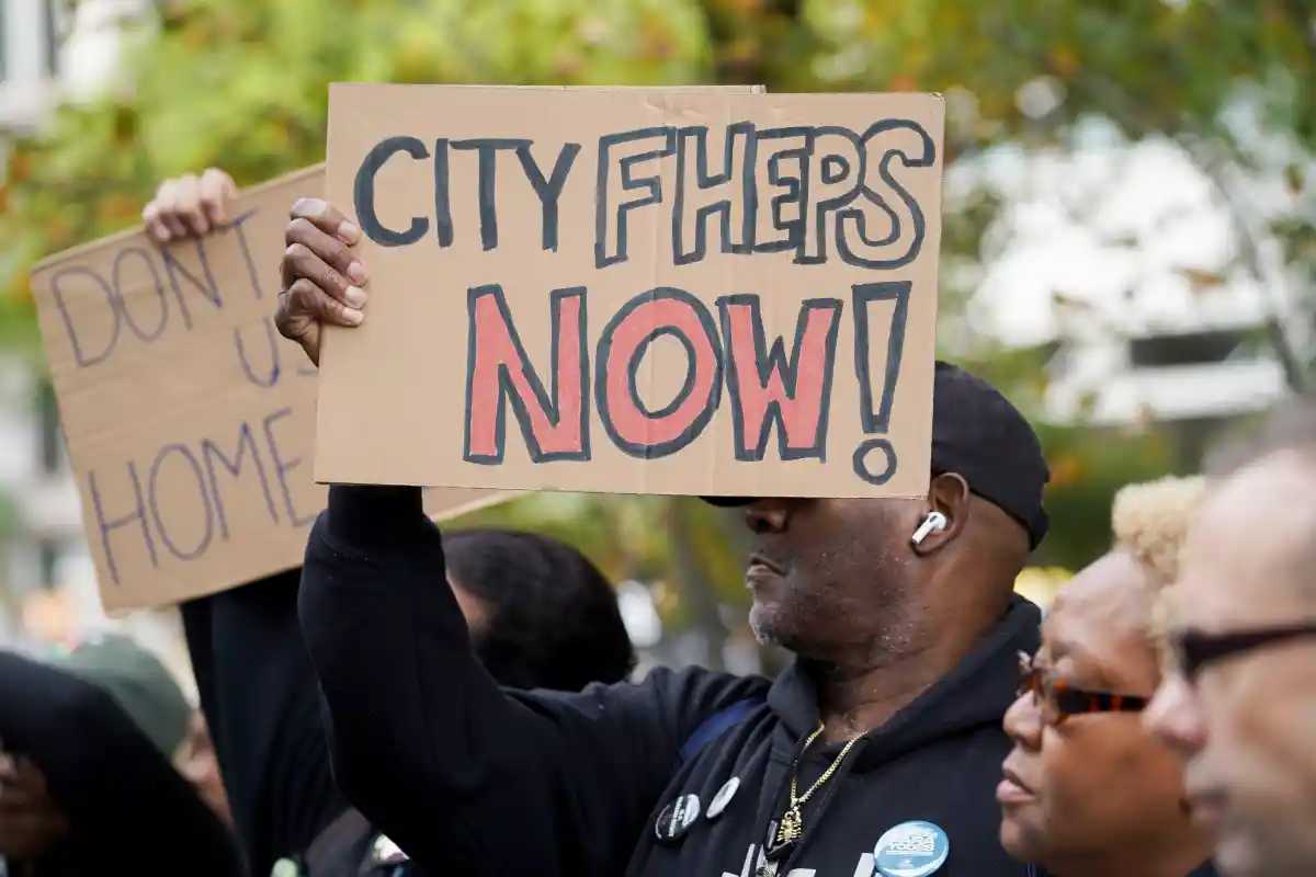 NYC’s largest housing voucher program expands, but lawmakers say it’s not enough 2 A man holds a sign at a rally that reads "CityFHEPS Now!"