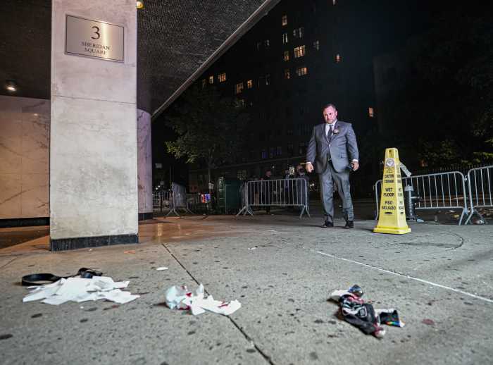 Stonewall shooting: Two teen girls shot near historic Village inn during Pride celebrations 6 Man in suit looks at crime scene with blood and napkins on sidewalk