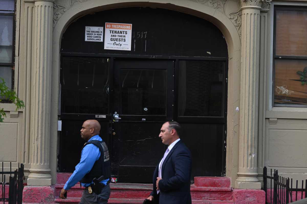 Police in Brooklyn walk by building where shooting occurred