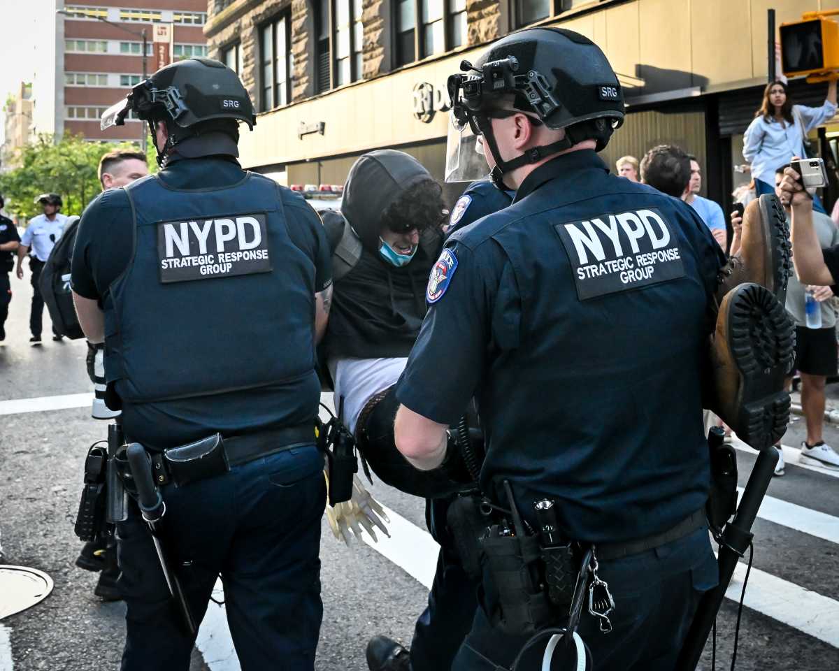 Police drag away protester during ICE raid upheaval