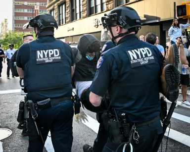 Police drag away protester during ICE raid upheaval