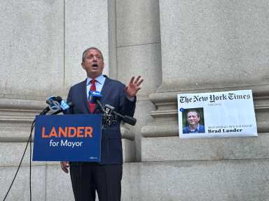 Brad Lander with copy of New York Times endorsement in primary race