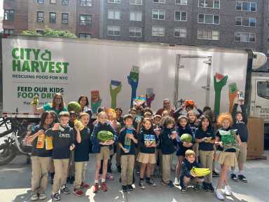 Upper East Side children standing as group in front of City Harvest truck during food drive