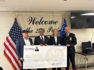 NYPD commissioner and Espaillat holding check for camera funding