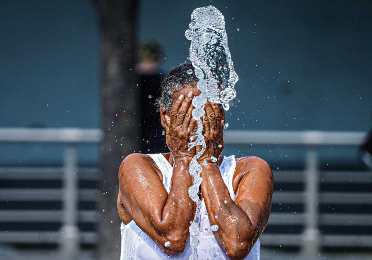 Extreme heat warning in NYC: How to stay cool during the upcoming heat wave 1 New Yorker splashing water on face during extreme heat wave