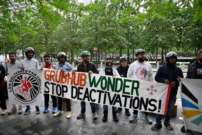 Food fight: Grubhub fires 50 delivery workers, sparking protest in Lower Manhattan 2 Delivery workers holding a sign that reads Grubhub wonder stop deactivations