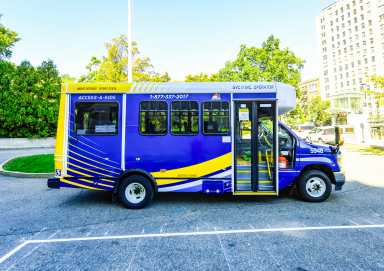 MTA blue and yellow Access-a-Ride van parked in lot