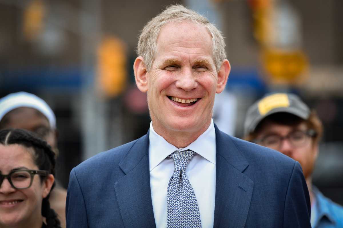 man smiling while wearing suit