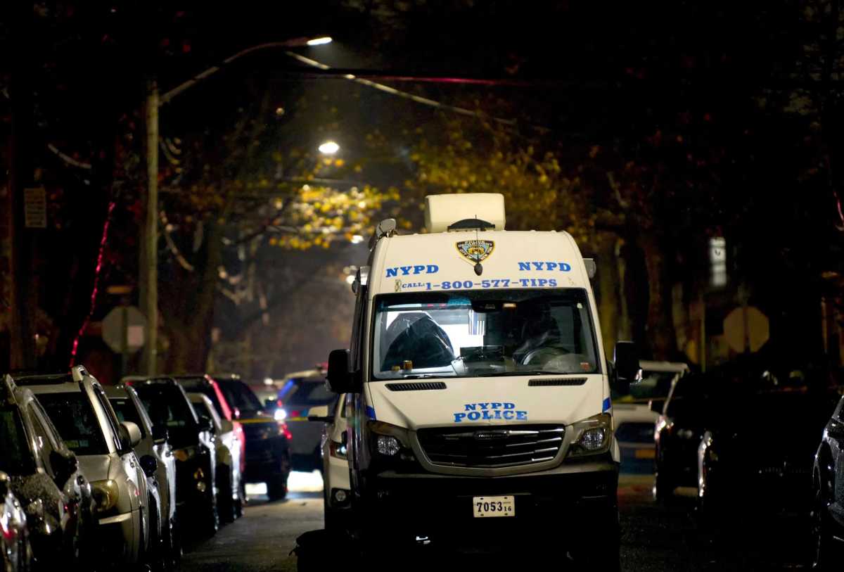police vehicle on darkened block at scene of crime