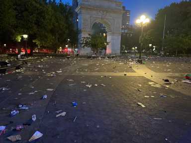 debris left on ground near big arch in park