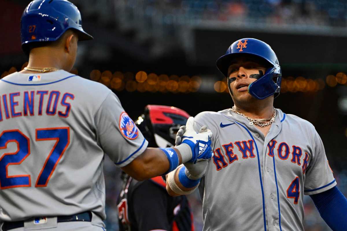 Francisco Alvarez Mark Vientos Mets: Baseball players in grey uniforms congratulate each other