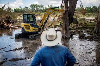 Texas floods spur nationwide relief efforts from local charities, New York groups 17 A person watches as machinery is used to clear debris along the banks of the Guadalupe River after catastrophic floods in Center Point, Texas, U.S., July 11, 2025. REUTERS/Sergio Flores TPX IMAGES OF THE DAY