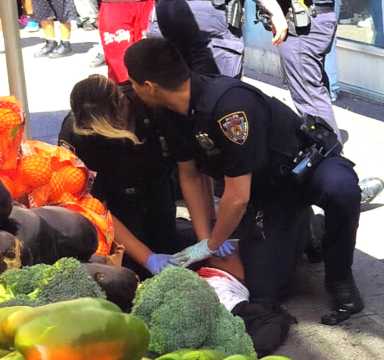 Cops are observed giving chest compressions to the gunshot victims.