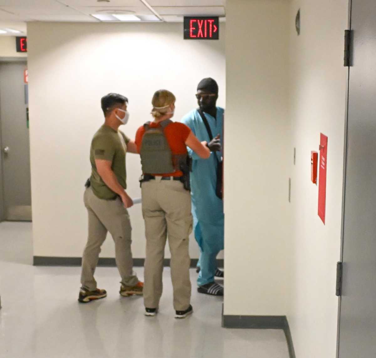 Immigrant man in blue apprehended by ICE agents and led into stairwell