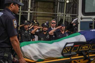 police officers saluting body of slain cop after midtown mass shooting