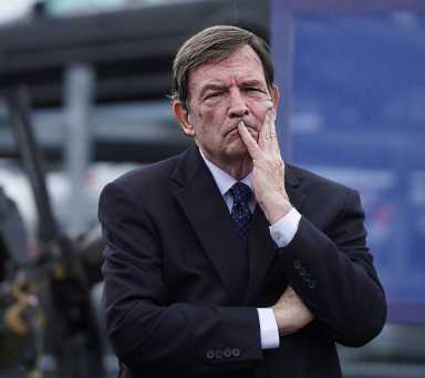 man in suit with hand on chin at NYPD event