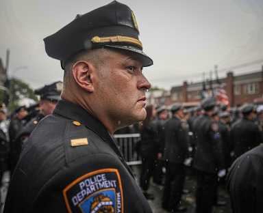 Bleeding blue: Why is the NYPD losing an average of 300 cops per month? 32 NYPD officer staring at funeral for fallen cop