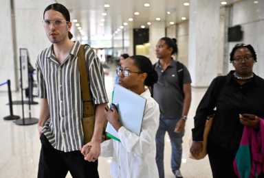 Love in the time of ICE raids: Newlyweds face immigration court judge in Lower Manhattan hoping to stay together 17 Man and woman holding form while walking inside immigration court