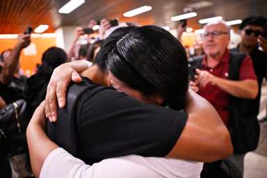 Derlis Snaider Chusin Toaquiza, 19, embraces his family after arriving at Port Authority Bus Terminal on Friday